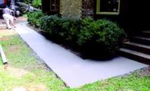 This walkway with re-entrant corner at one end and a curve at the other with no joints remains crack-free after more than three and a half years. The crew struck-off, floated, and edged by hand.