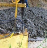 Near zero-slump concrete is often what road builders look for when using a slipform paver. Placing, consolidating, and finishing it by hand would be nearly impossible.