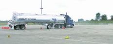 Computerized stability control, standard in many new-model trucks, keeps top-heavy vehicles from rolling over. Here's what happens when a truck without the feature swerves suddenly: only special outriggers keep the tanker upright. Photo: Bendix Commercial Vehicle Systems