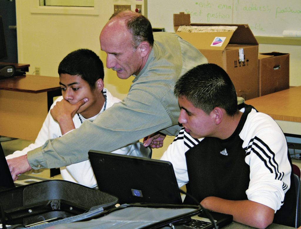 With approval form a teacher or club leader, GeoMentors can work with youth as well as adults. GIS professional Doug Miller, city planner at Hillsboro, Ore., helps youth work on a tree inventory.