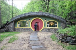 Above, the Hobbit home’s front facade. Built to Passive-House standards, the home’s features include: low air infiltration; super-insulated walls, roof, and floor; high-performance windows and exterior doors; energy recovery ventilation; and ADA accessibility (inside and out).