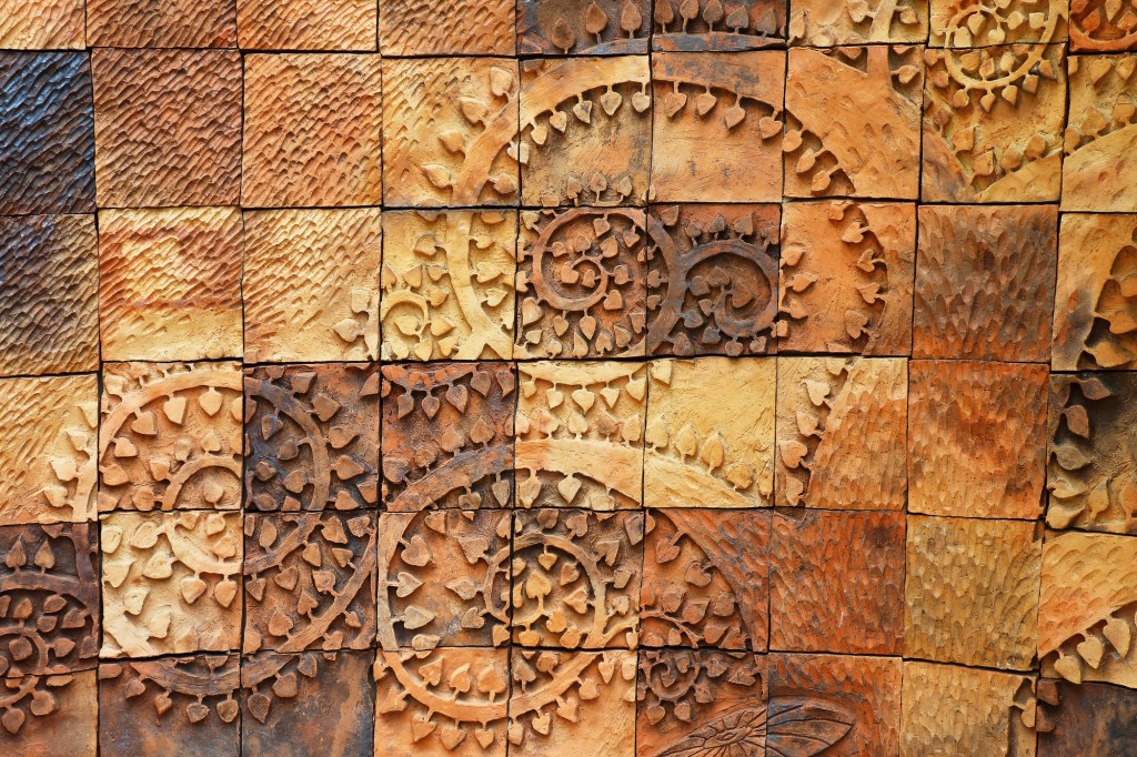 Vertical overlays are specially formulated, lightweight cement-based mixtures that adhere to any primed wall surface without sagging. They can be stamped and colored just like horizontal overlays and even carved.