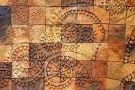 Vertical overlays are specially formulated, lightweight cement-based mixtures that adhere to any primed wall surface without sagging. They can be stamped and colored just like horizontal overlays and even carved.
