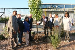 McInnis Cement plants a maple tree with officials and members of community organizations to celebrate the opening of the Bronx cement terminal, which includes a quarter-mile public portion of the South Bronx Greenway. From left to right: Ramon Cabral, Deputy District Director; Nick Madio, Bronx Community Board 2; Maria Torres, President & COO, The Point; Laurent Beaudoin, Chairman, McInnis Cement; Jean Moreau, President and CEO, McInnis Cement; Rafael Salamanca, Councilman & Chair of the Land Use Committee; Ralph Acevedo, District Manager, Bronx Community Board 2; and Dondi McKellar, Veterans Committee, Bronx Community Board 2.