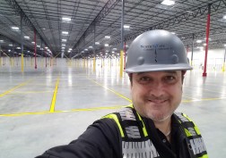 Scott Tarr inspecting a large commercial concrete floor.