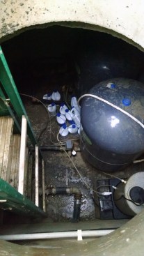 The well pit has the expansion tanks and chlorine feed equipment. The Water and Sanitation District was collecting $100 a month but was unable to build up cash reserves because poor well design had caused multiple pump failures in the few years it was in operation. 