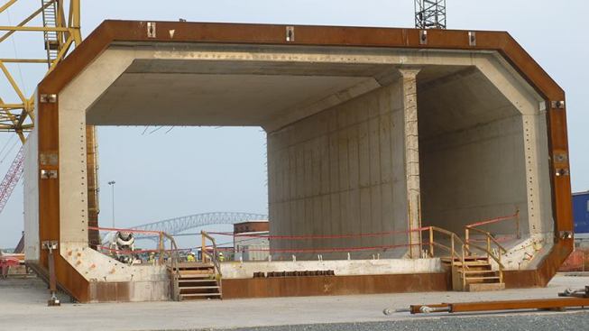 The first six massive tunnel elements (litter 1) arrived at the Portsmouth Marine Terminal in summer 2014, after being towed one at a time by a tug fleet down the Chesapeake Bay. The remaining five concrete tunnel elements were completed at the Sparrows Point fabrication dry docks and prepared for float-out to the Virginia jobsite. This process included sealing and waterproofing the elements, constructing four temporary, interior ballast tanks in each to provide stability during floating and towing, and installing temporary bulkheads on each end to allow the elements to float.
