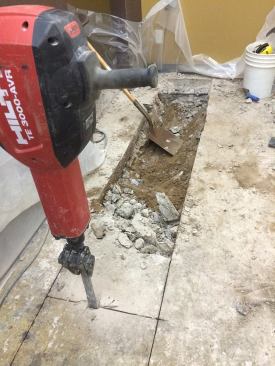 Before concrete repair could begin, 20 feet of the old floor were cut with a wet saw to allow installation of a new drain and plumbing for the shop.