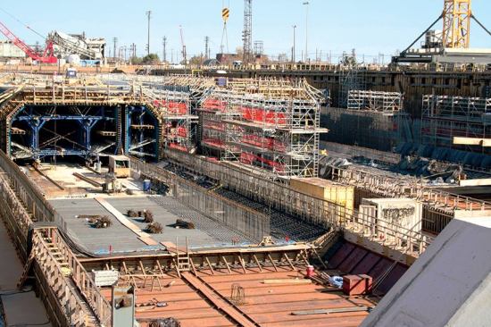 The blue steel frames, called the main form traveler (on the left in photo) and the egress form traveler (right), were used to form the concrete into the element shape. The Parsons Brinckerhoff rectangular profile design of the second Midtown Tunnel is the first deepwater concrete immersed-tube tunnel in North America and only the second all-concrete immersed tunnel in the U.S.