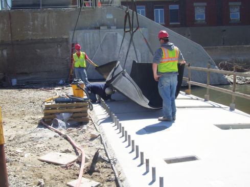Air bladders consist of reinforced, layered rubber, approximately ¾ inch thick. Each bladder has special fittings that connect to embedded air piping via flexible connections.