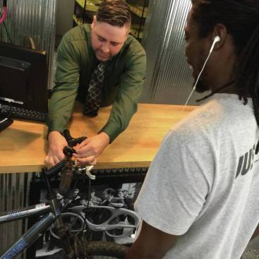 James DesLauriers, lead bike tech, helping out a happy customer. 