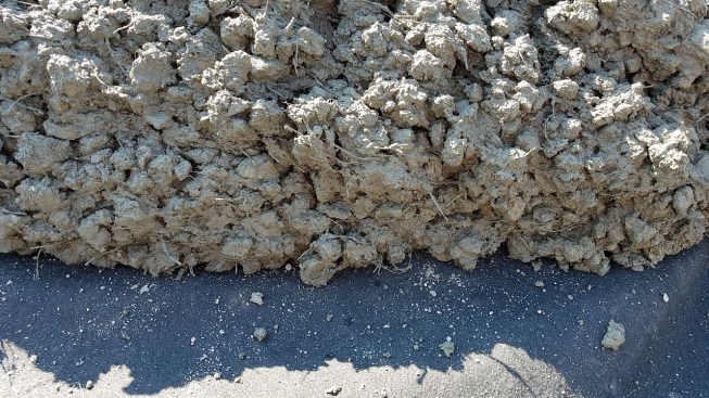 Getting fibers properly mixed, especially into very low slump batches like this highway overlay, can be difficult.