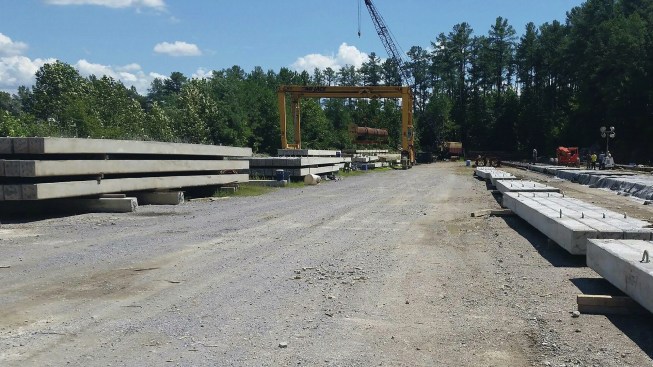 When the finished piles in the storage yard reach their 7-day strength of 6,000 psi, they are loaded onto trucks for transport to the Union Place construction site.