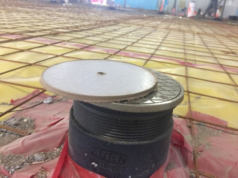 A layer of Thermo-Ply atop the cleanouts defined the finished elevation of the floor.