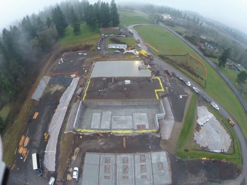 In this photo, the basement has all of its walls in place and braced. The tilt-up panels for this part of the building have been cast on the basement slab and on the adjacent rat slab below and are ready for placement. At the top of the photo, half of the slab-on-grade for the main level has been poured. 