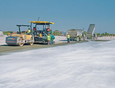 Twenty Seven acres were paved for the new intermodal terminal. It took three to four minutes to place a semi load of RCC with a high-density paver. After a couple passes with a roller compactor the pavement density exceeded 98%. 