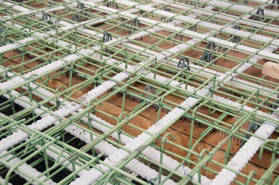 The Upper Wacker deck has PT ducts (white plastic) running every 2 ft. in both directions to control cracking and permit a thinner deck. Notice the draped ducts at top right, adding support to midpanels.