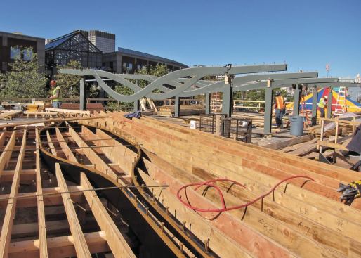 The steel beams in the background are the structure for one of the pavilions on the Boston Harbor project. The rib forms are in place in the foreground, cut for a precise location by a CNC router. Notice how they fit alongside the structural steel beams.