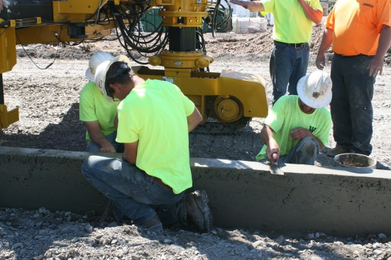 On this first project, repairs were needed in areas where the concrete was too wet and could lead to sagging or too dry and cracking. One of the most important aspects of slip forming curbs is maintaining the correct concrete slump. When the slump is correct, minimal or no hand work is needed other than texturing. 