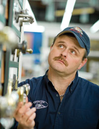SALES OPENERS: Mark Woody, senior contractor sales leader at Spencer Home Center in Lexington, Va., examines a line of door hardware that Spencer began selling with great success a few years back. Like many other dealers, Woody believes he can gain a competitive edge by alerting customers to new products and demonstrating how to install them.