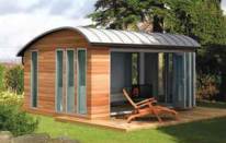 STYLISH GETAWAY: A number of companies have noticed increasing demand for outbuildings and are creating smart, high-tech structures that can be used as a space for telecommuters or as a hobbyist's retreat. This is the "Curved Lodge" model from the British company Decorated Shed.