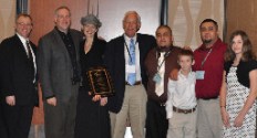 WBMA president Eric Fritch presents the Dealer of the Year award to Lake Chelan Building Supply: Brett LaMar, general manager; Sheri LaMar, Brett's wife; Edd LaMar, a founder of the store and Brett's father; Johnny Morfin, an employee; Bryce LaMar, son of Brett and Sheri; Bart Morfin, an employee; and Alyssa LaMar, daughter of Brett and Sheri.