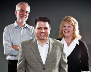 SMALL HQ, BIG PLANS: U.S. LBM president and CEO L.T. Gibson (center) intends to keep the new company's central office as small as possible. Along with information technology, the main services run by headquarters staff are finance, headed by vice president Brian Hein (left) and human resources, directed by Karen Charielle (right)