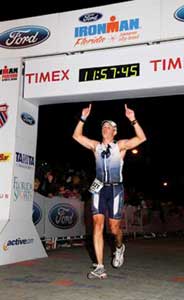 Jimmy Sobeck Jr. crosses the finish line at the Ironman Triathlon in Panama City, Fla.