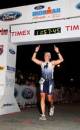 Jimmy Sobeck Jr. crosses the finish line at the Ironman Triathlon in Panama City, Fla.