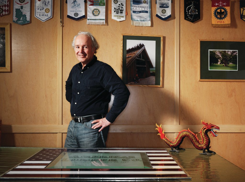 MODESTO, CALIF - Jan 21, 2013.  Portrait of John Mensinger, owner of the American Lumber Company in Modesto, California.  Photo taken inside his office in Modesto.  Hanging on the wall above Mensinger are banners from various Rotary Club chapters throughout the world that he has visited.  Photo by John Lee.COPYRIGHT 2012 JOHN LEE PICTURES.www.johnleepictures.com