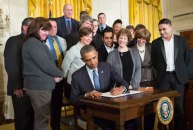 President Obama signs order on March 13 directing the Labor Department to revise federal rules governing overtime pay.