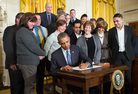 President Obama signs order on March 13 directing the Labor Department to revise federal rules governing overtime pay.