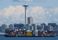 A barge leaves Seattle laden with goods Uresco was shipping to Alaska