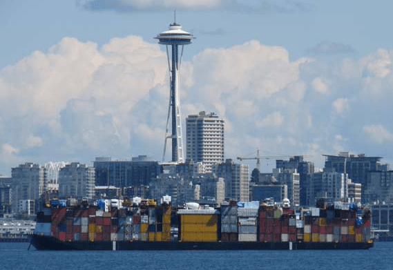 A barge leaves Seattle laden with goods Uresco was shipping to Alaska