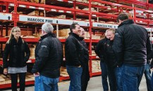 Senior members of the Hancock Lumber team chat as they get ready for a group shot