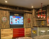 The "man cave" vignette at Curtis Lumber's showroom in Ballston Spa, N.Y., includes its own bar with custom stools, a flat-screen TV, and a couch for customers to lounge on.