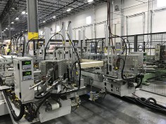 Many manufacturers, including MI Windows as shown here, are beginning to invest in robotic equipment for glass manufacturing lines in order to reduce human error.