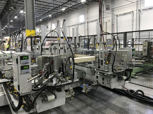 Many manufacturers, including MI Windows as shown here, are beginning to invest in robotic equipment for glass manufacturing lines in order to reduce human error.