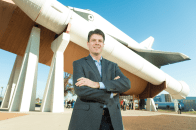 Wilson Lumber President Robb Wilson stands before a test version of the space shuttle