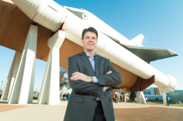 Wilson Lumber President Robb Wilson stands before a test version of the space shuttle