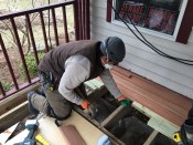 Tiger Claw TC-3 deck clips are tapped into the edge of the decking with the help of a manufacturer-supplied installation tool (the green plastic block shown in the photo).