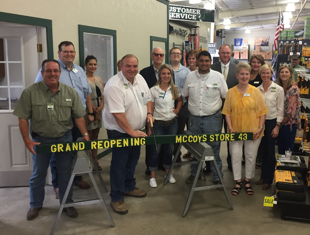 McCoy's Building Supply corporate executives join with employees of the Huntsville, Texas, facility and local Huntsville officials to celebrate the grand re-opening of the store.