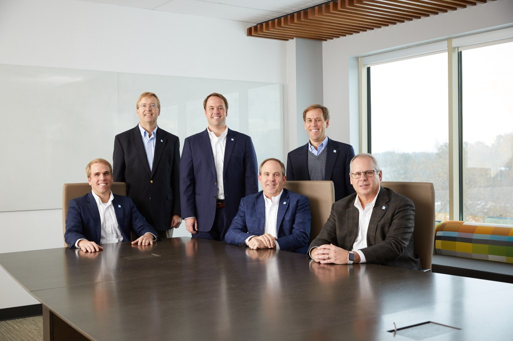 Lansing is truly a family business, with brothers Chase (seated, far left); Hunter (standing, middle); and Ted (standing, far right) all working at the corporate headquarters.