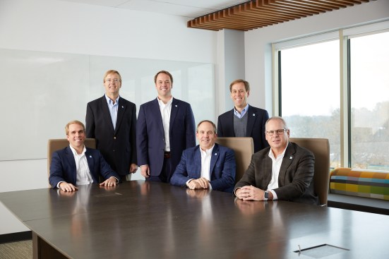 Lansing is truly a family business, with brothers Chase (seated, far left); Hunter (standing, middle); and Ted (standing, far right) all working at the corporate headquarters.