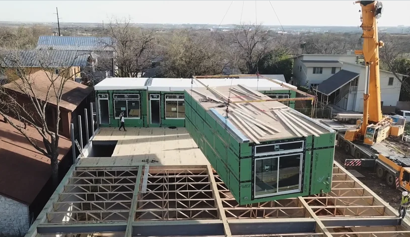 A crane lifts a unit into place on the 24,000-square-foot mixed use MLK project just outside of downtown Austin.