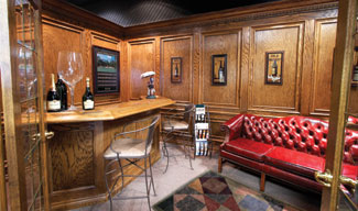 Bolyard Lumber pulls out the product shelves and puts in a showroom (complete with wine cellar) that has transformed it into an exclusive, high-end operation. Shown here: a pub-style bar showroom lined in oak.