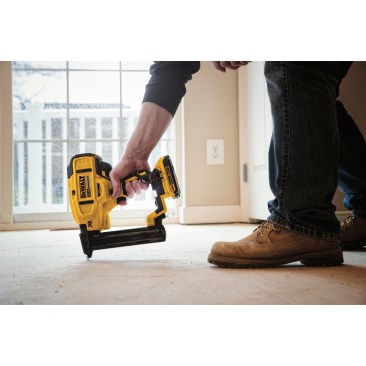 The DeWalt DCN681D1 Cordless Stapler in use on jobsite nailing off subloor.
