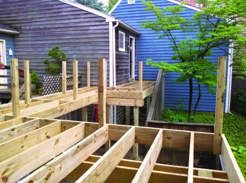 Tacking guard posts in place as the deck is framed ...