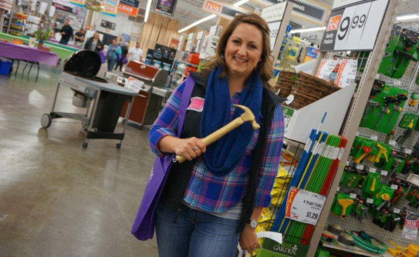 A customer shows off the Golden Hammer, good for a prize at Gillman Home Center