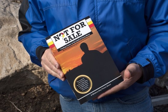 Kevin Hancock holds his book, “Not For Sale: Finding Center in the Land of Crazy Horse” about his experiences on the Pine Ridge Indian Reservation and with the Oglala Sioux tribe.